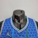 camiseta hornets azul city cuello en V con borde celeste y blanco y azul y el logo jordan