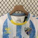 Conjunto Niño Málaga Primera Equipacion 2024-2025 pecho