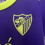 Conjunto Niño Málaga Segunda Equipacion 2024-2025 logo